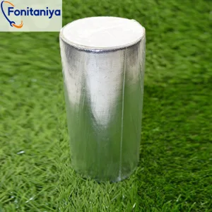 a roll of aluminum artificial turf tape on a synthetic grassland