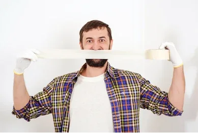 a satisfied worker with a roll of painter's tape