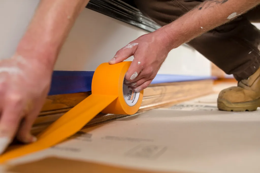 removing an adhesive tape from the metal surface