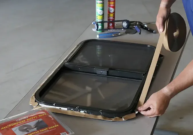 applying waterproof butyl tape on rv window