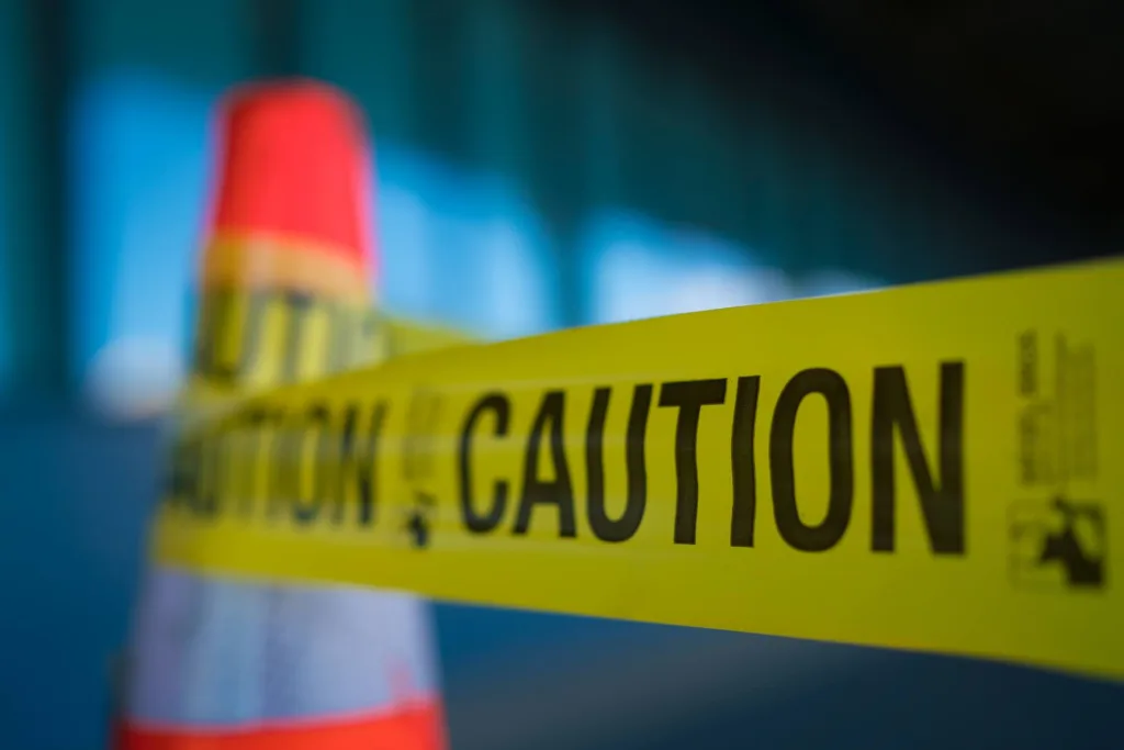 a yellow barricade tape is wrapping on the scene