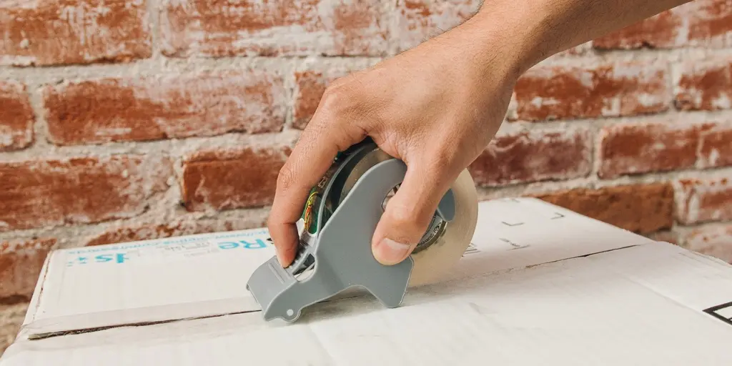 packing a carton box with packaging tape