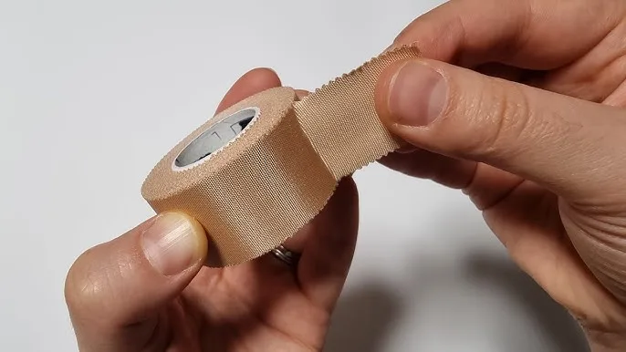 stretching a roll of zinc oxide sports tape