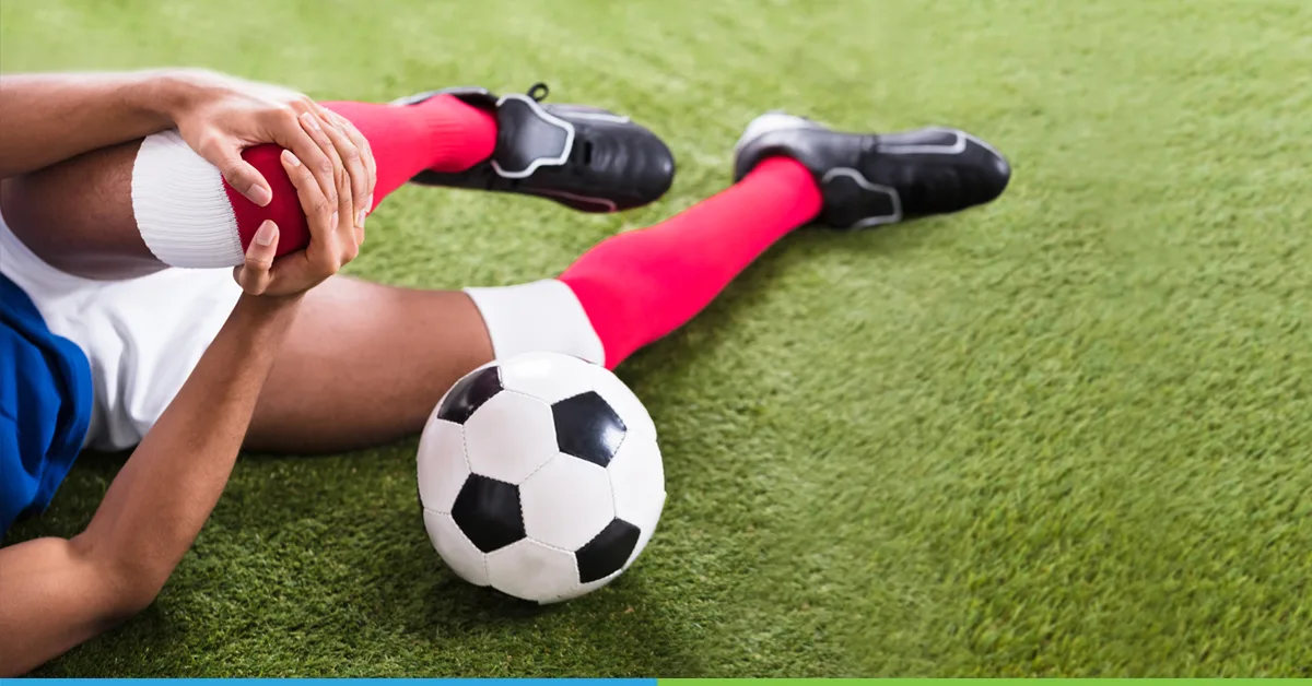 football player suffering from pain with zinc oxide tape on his wound