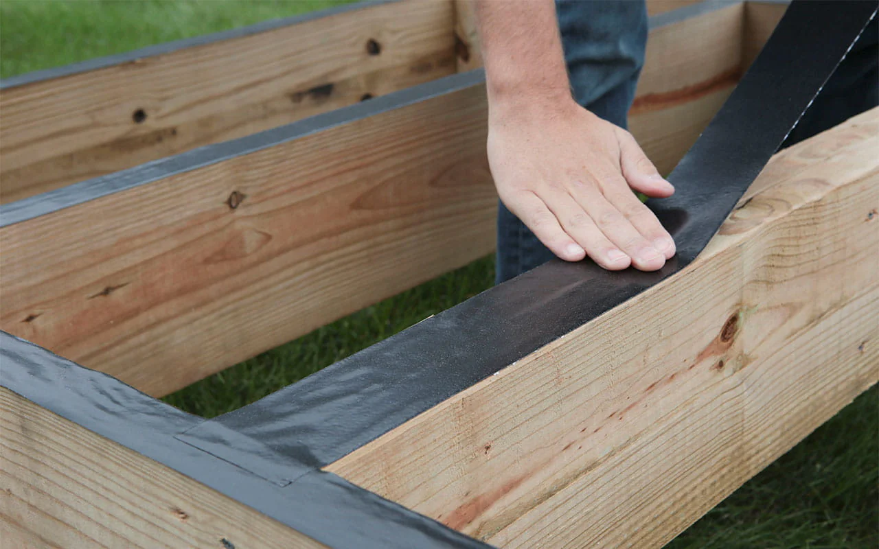applying joist tape to the deck