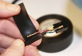 a person is using pvc electrial tape to wrap electrical wires